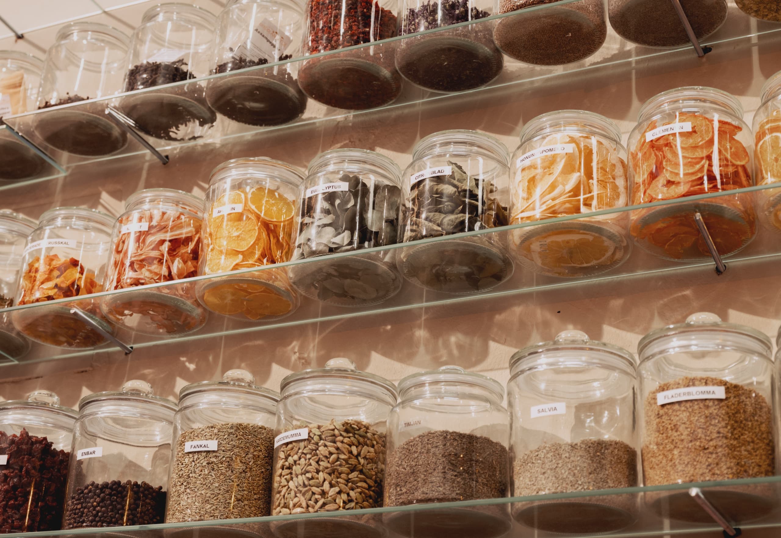 Wall of glass jars filled with botanicals at the distillery